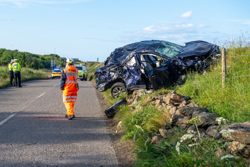 The crashed vehicle on the side of Coast Road.