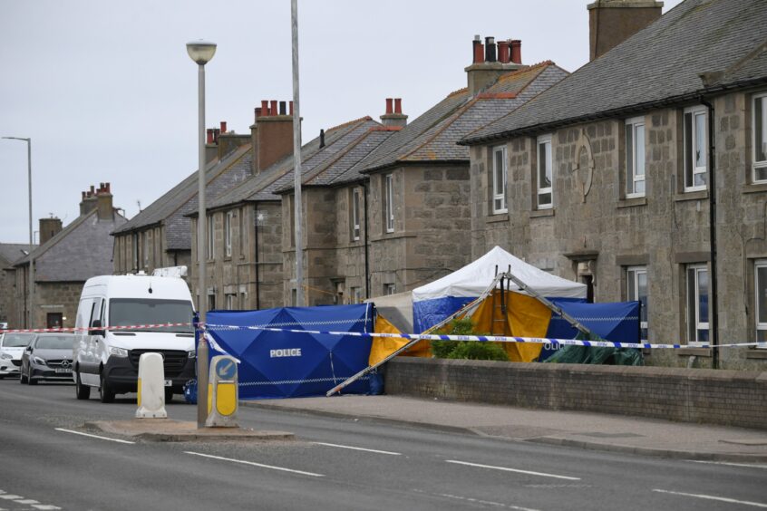 Blue police tents and a forensics van around a home on Watermill Street, Fraserburgh. 