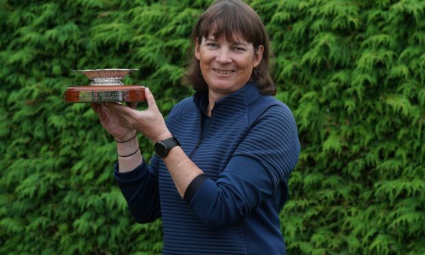 Karen Ferguson-Snedden scoops the trophy for third year running at Scottish Senior Women's Open. Image: Scottish Golf.