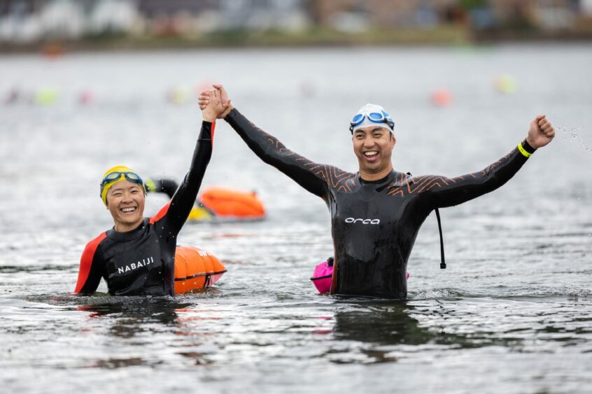 Two swimmers cheer as they made it to the other side of the Moray Firth.