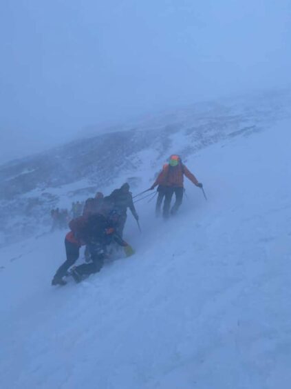 Rescue team battling through severe weather conditions to rescue the group of walkers trapped on Ben Nevis. 