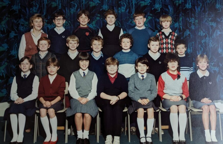 The only school she ever taught at, Mrs Craig is shown with one of her classes.