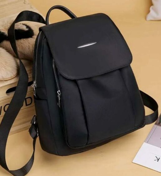 A bag similar to the one that caused the accident. A small black handbag/backpack with two long straps