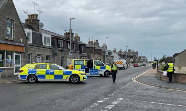 Police vehicles parked across Constitution Street in Inverurie to prevent access.