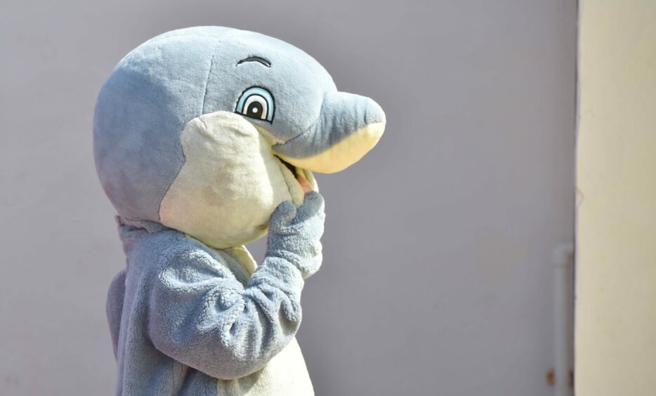 A person dressed up as a dolphin.