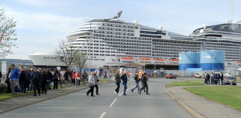 People line the streets as The MSC Cruise Ship, MSC Meraviglia, docks in Invergordon. 
