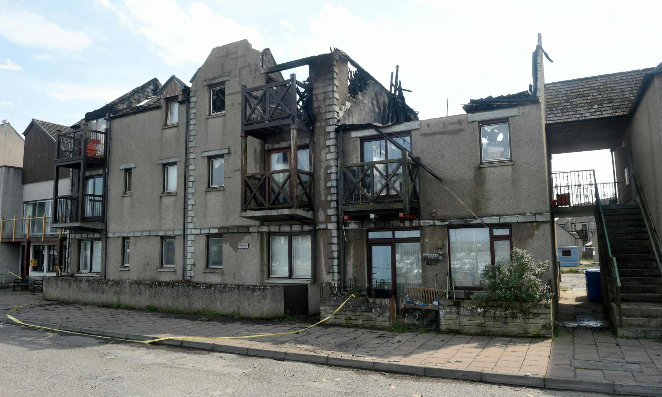 Looking at front of Harbour Street flats in Nairn with roof gone following fire. 