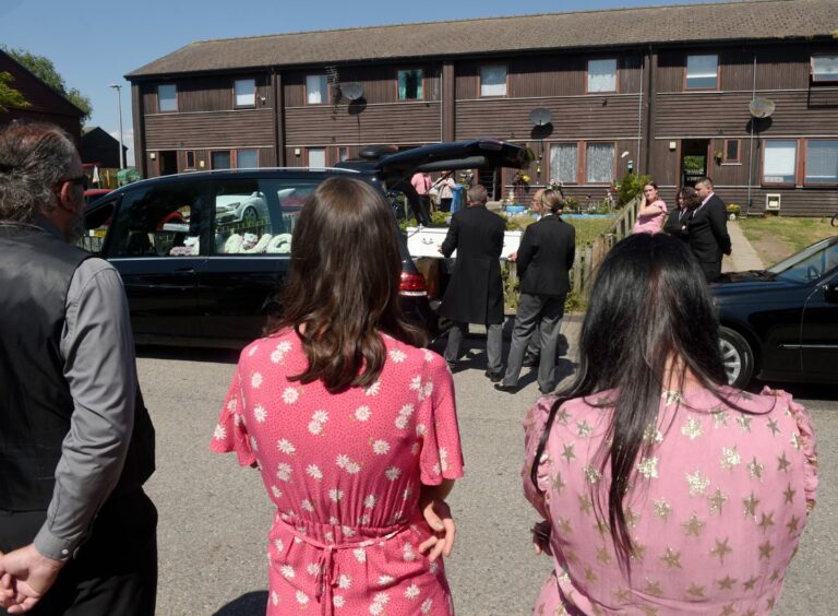 Onlookers watch as the coffin of 14-month-old Mia is placed in the funeral car. Image by Sandy McCook / DC Thomson.