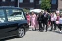 The parents of baby Mia Macphee lead her funeral procession today in Milnafua, Alness.