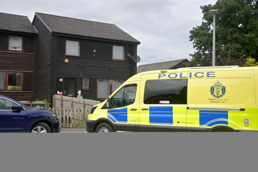 Police van at the home in Milnafua, Alness, where the alleged murder is said to have occured.