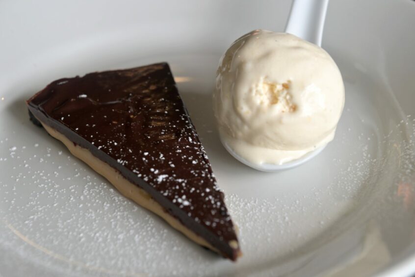 Chocolate and caramel torte with a crushed Oreo base served with homemade vanilla ice cream.
