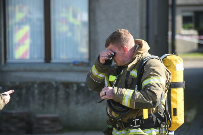 A fireman rubbing his eyes at the fire at Cannich. 