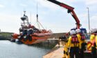 RNLI lifeboat being lowered into the water.