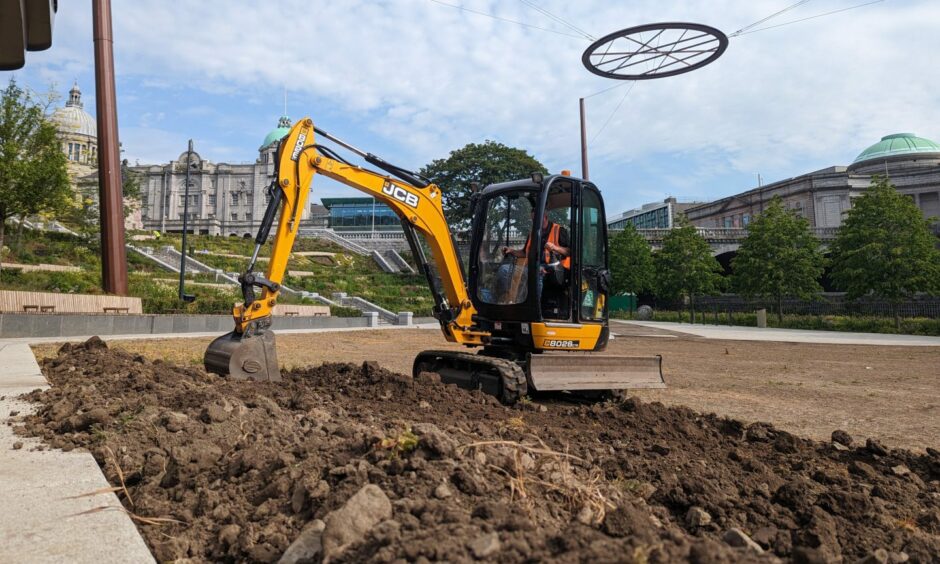 A digger prepares the sun-dried UTG lawn for turfing. Earlier this week, Our Union Street took the keys for the Union Street pavilion above the Victorian park. Image: Alastair Gossip/DC Thomson
