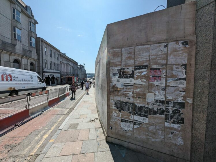 Campaign posters wallpapered the hoardings at the Market Street and Hadden Street sides of the Aberdeen market site.