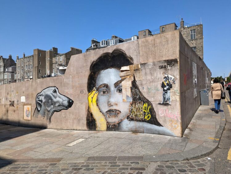 Paintings on the hoarding surrounding the Aberdeen market building site.