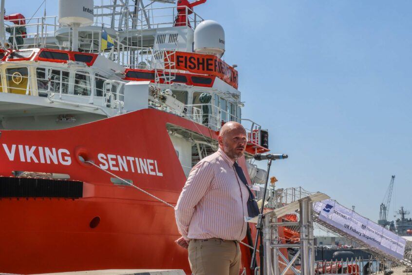 Marine Management Organisation director Peter Clark in front of Viking Sentinel.