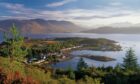 Looking down to Plockton on the south side of Loch Carron, from a heather covered hillside above the village. Supplied by Highland Coast Hotels