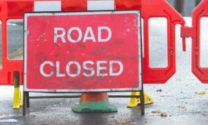 A "road closed" sign on the road.