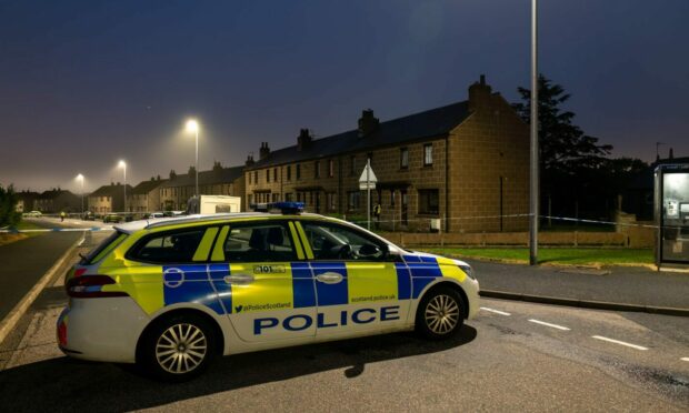 Police car parked outside a property on Catto Drive in Peterhead.