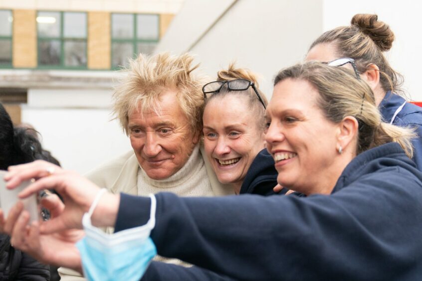 Sir Rod Stewart has a selfie with fans after showing up at Princess Alexandra Hospital in Essex earlier this year to pay for extra cancer scans.