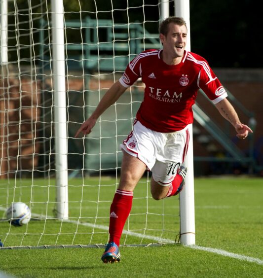 Niall McGinn pictured celebrating a goal wearing the 2012/13 kit 