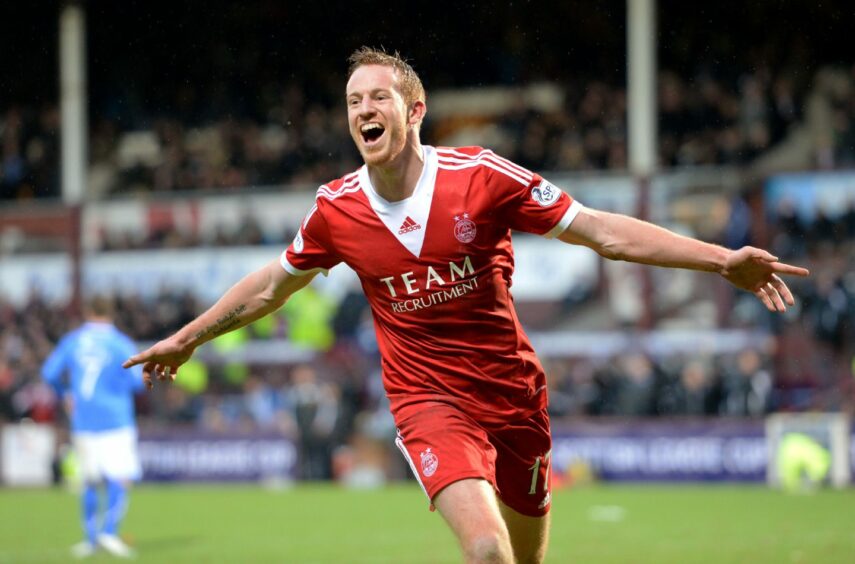 Adam Rooney celebrates his 2014 League Cup semi-final goal against St Johnstone in the 2013/14 home strip, which featured a big white V at the neck.