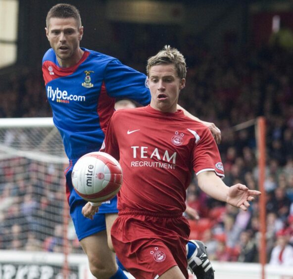 Chris Maguire in action wearing the Dons' 2008/09 club strip.