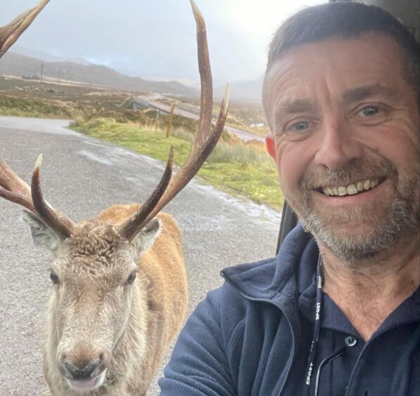 Scott Mitchell posing with a stag.