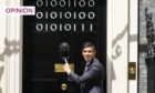 Prime Minister Rishi Sunak stands at the door of 10 Downing Street - the numbers stuck to the door spell out 'London Tech Week' in binary code (Image: Stefan Rousseau/PA)