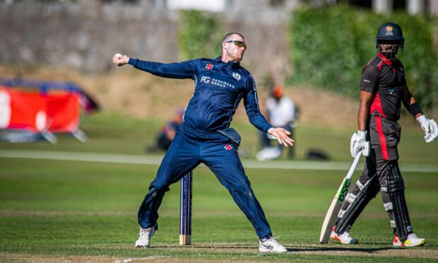 Michael Leask, left, took two wickets in Scotland's loss to Zimbabwe