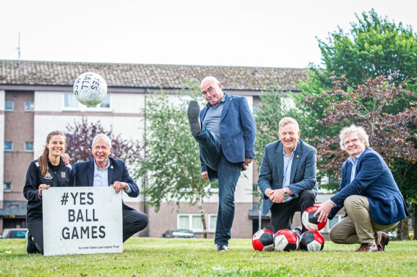 Europe-conquering Dons captain Willie Miller got the ball rolling at the Tillydrone Cruyff Court site in August, as Kiara Coutts, David Suttie, and councillors Alex Nicoll and Ian Yuill watch on. Image: Wullie Marr/DC Thomson