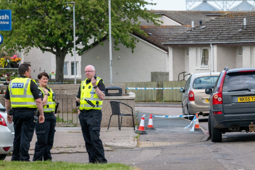 Police can be seen talking on Miltonn Drive in Buckie following a "stabbing" in the area. 