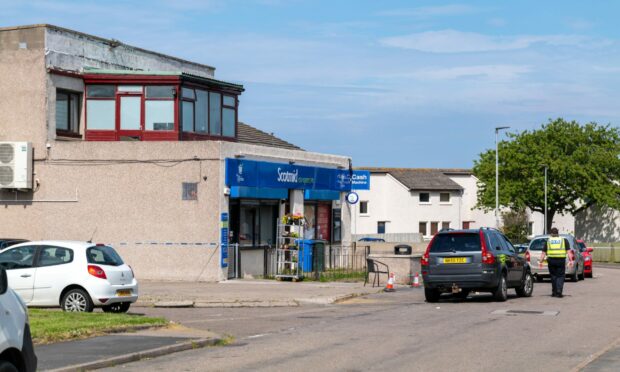 Police tape has been erected outside the Scotmid store and around Milton Drive as police remain at the scene.