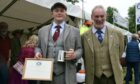 Young Gamekeeper of the Year award recipient Finlay Shand and Scottish Gamekeepers Association chairman Alex Hogg.