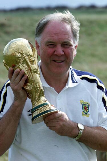Craig brown holding the World Cup trophy