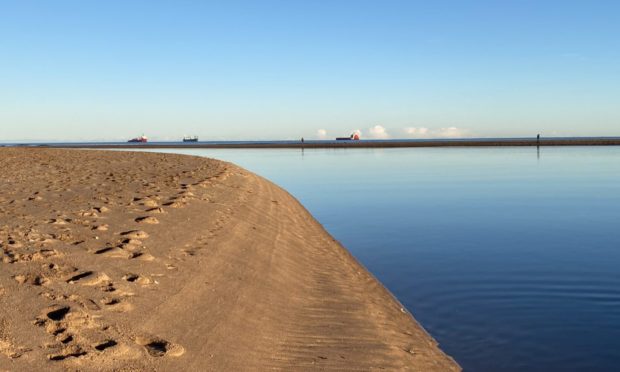 Police cordoned off the beach. Image: Alastair Gammack