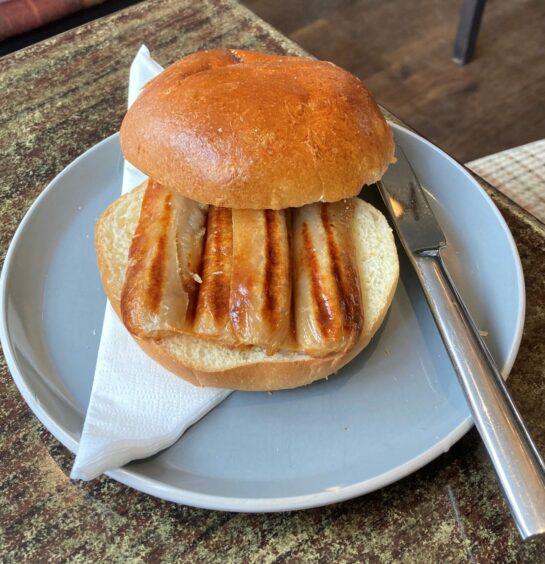 Sausage sandwich in a toasted brioche.