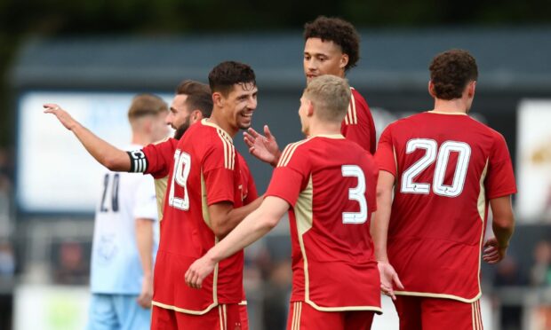 The Aberdeen players celebrate after making it 7-0 against Turriff United. Image: Shutterstock.