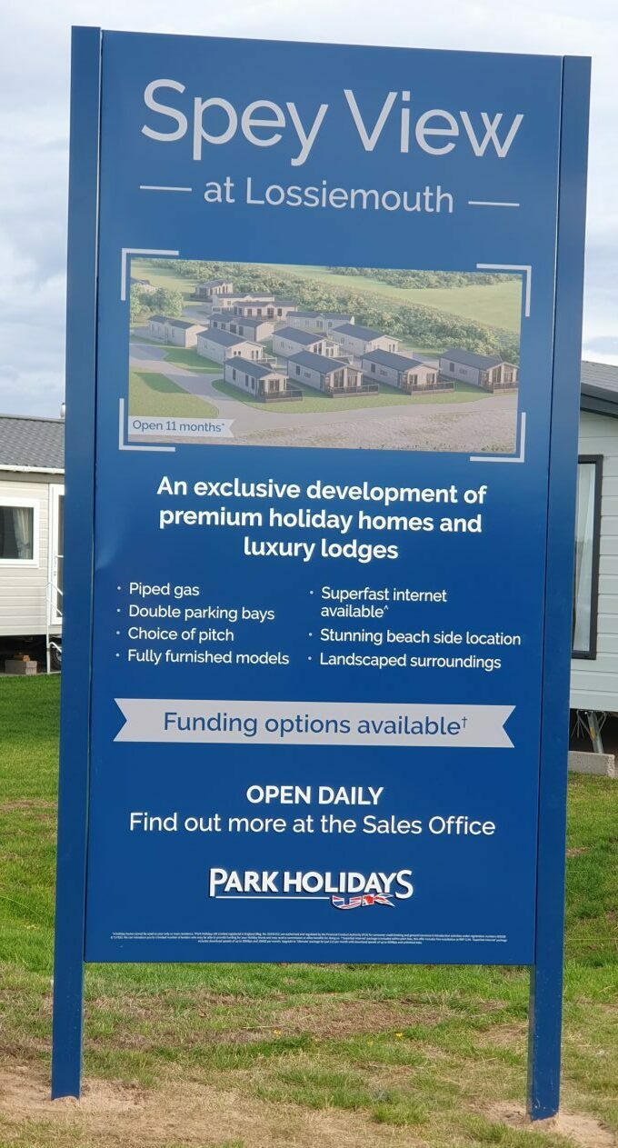 Close-up view of Spey View sign, explaining the holiday home and luxury lodges development. 