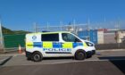 A police car leaving Nigg Bay Harbour in Aberdeen. Image: Cameron Roy.