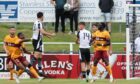 Elgin City player-manager Ross Draper has a header at the Motherwell goal with Blair McKenzie, number 14, also in close proximity