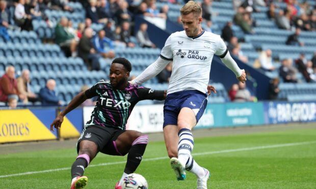 Aberdeen's Shayden Morris (L) and Preston's Liam Lindsay in action. Image: SNS