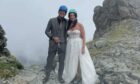 Mark and Victoria Lyons on Inaccessible Peak in Skye in wedding outfits. Image The pair tied the knot last week. Image: Belle Art Photography.