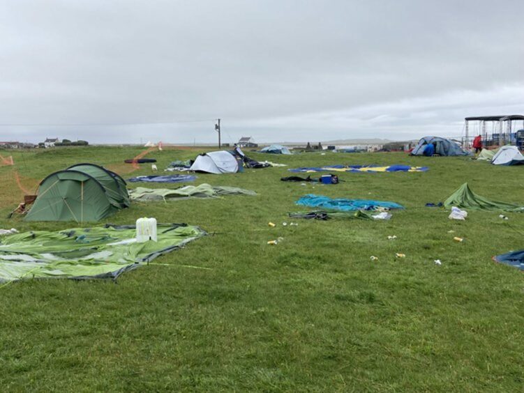 Tents strewn across the field on Tiree.