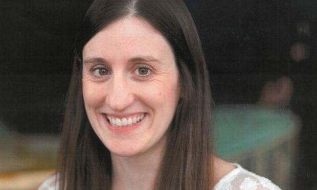 A photo of Mary Somerville, 39, smiling. She has brown hair and a white top on.