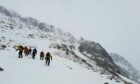 Mountaineers from Cairngorm Mountain Rescue Team battle through snow capped mountains during a rescue operation in the Cairngorms.