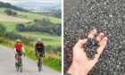 Neil Innes and Ian Hendry on bikes and a hand holding gravel