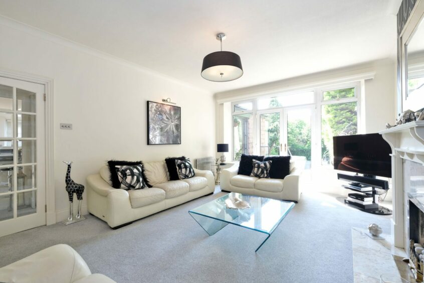 Large living room with black and white colour scheme.