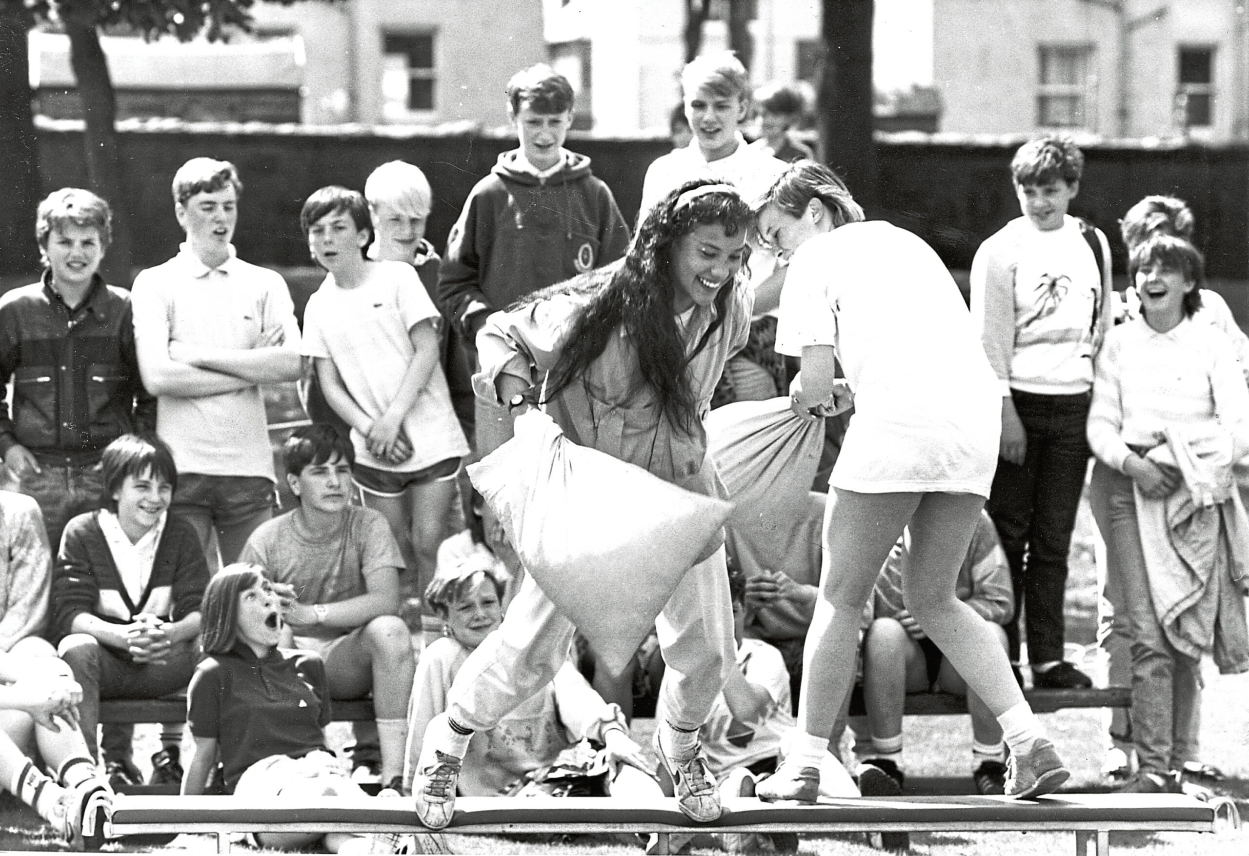 A crowd of children watching a pillow fight at Hilton Academy gala day